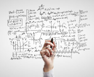 hand drawing mathematical formulas on a board